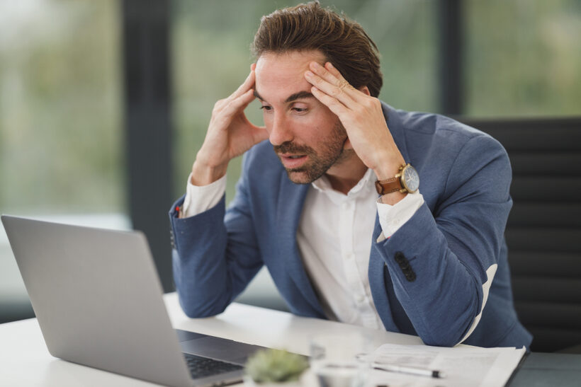 Frustrated person looking at a slow-loading website on a laptop