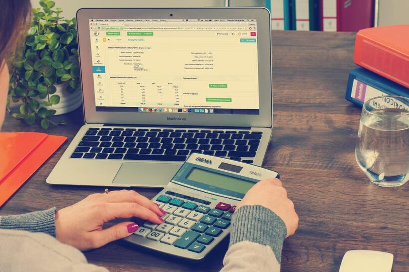 Calculator and pricing notes on a desk