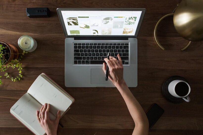 Notebook and laptop with website copy being drafted