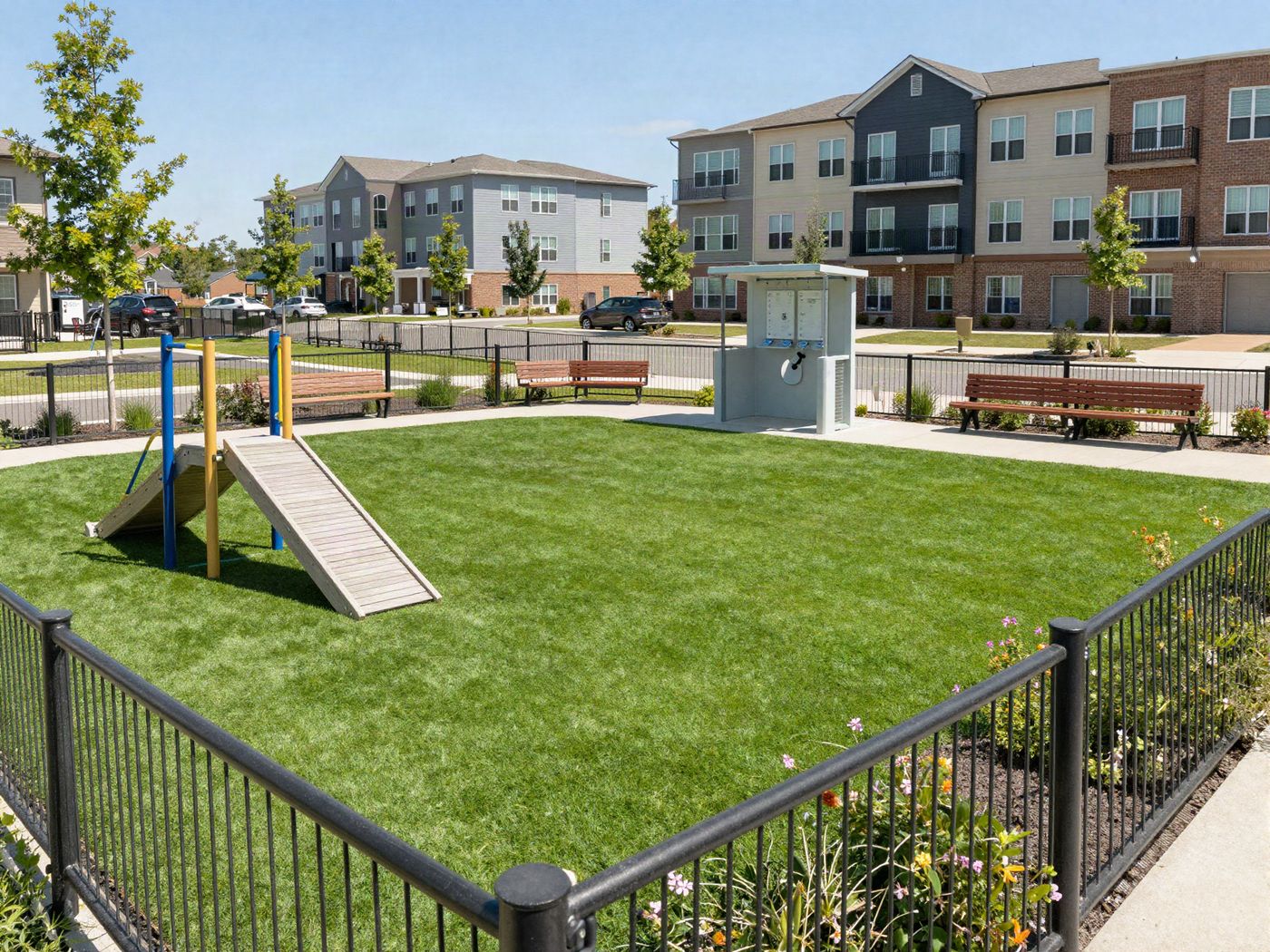 A fenced dog park with a path and benches