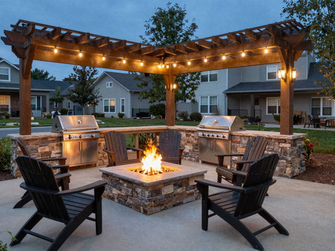 The grill pavilion and fire pit glowing at dusk